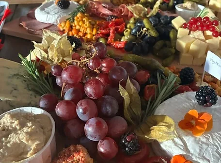 Charcuterie board with grapes and cheeses