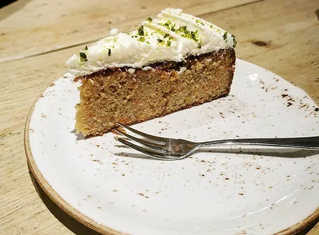 Slice of carrot cake with cream cheese frosting