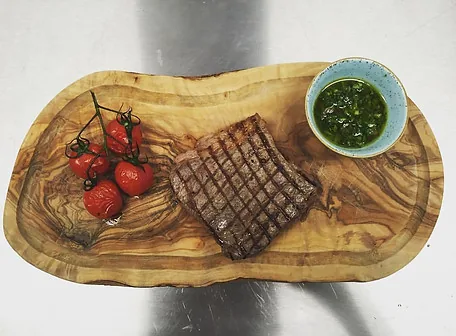 Steak board with chimichurri for a film crew